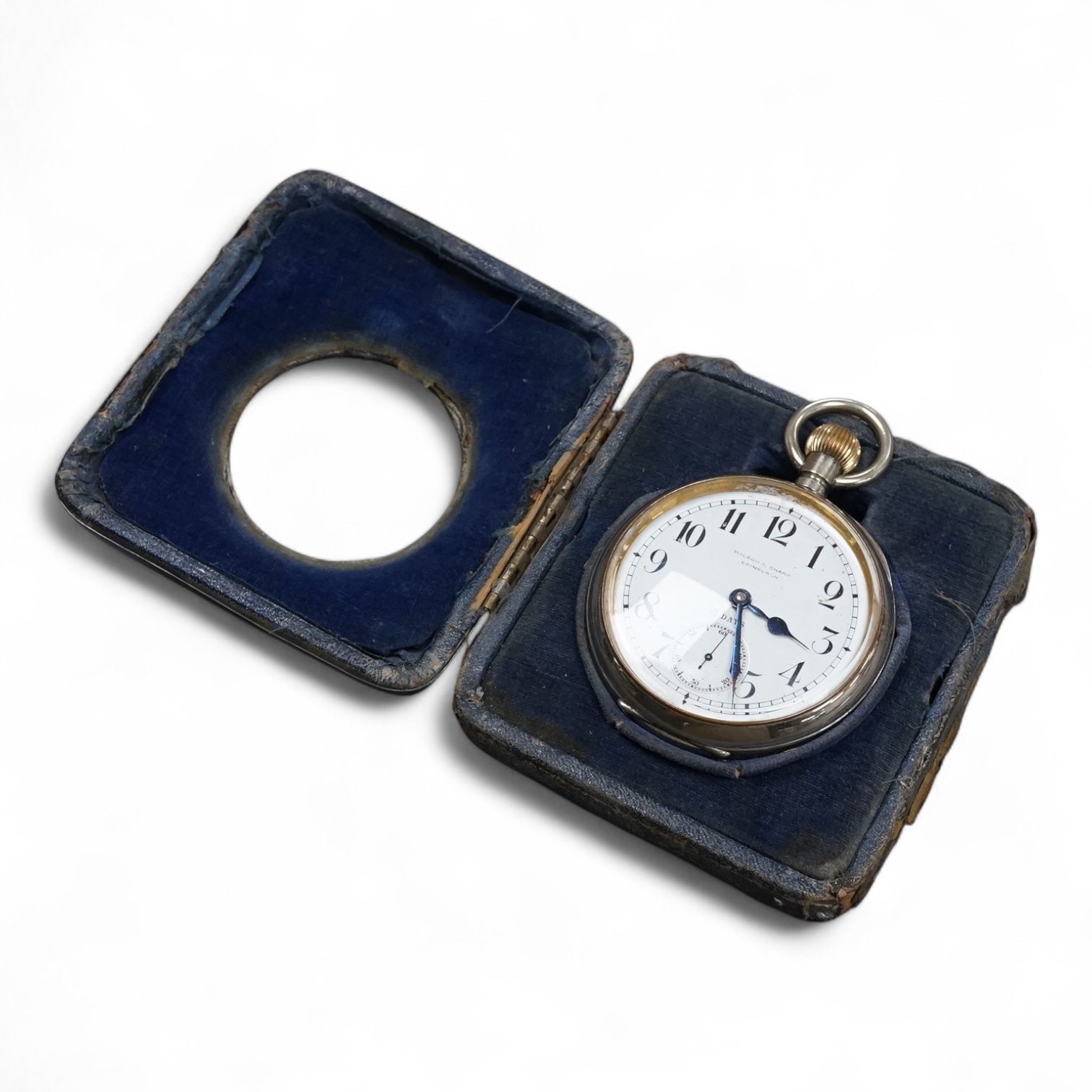 An Edwardian silver mounted travelling watch case, by William Comyns, London, 1903, width 10.2cm, containing a chrome cased pocket watch retailed by Wilson & Sharp.